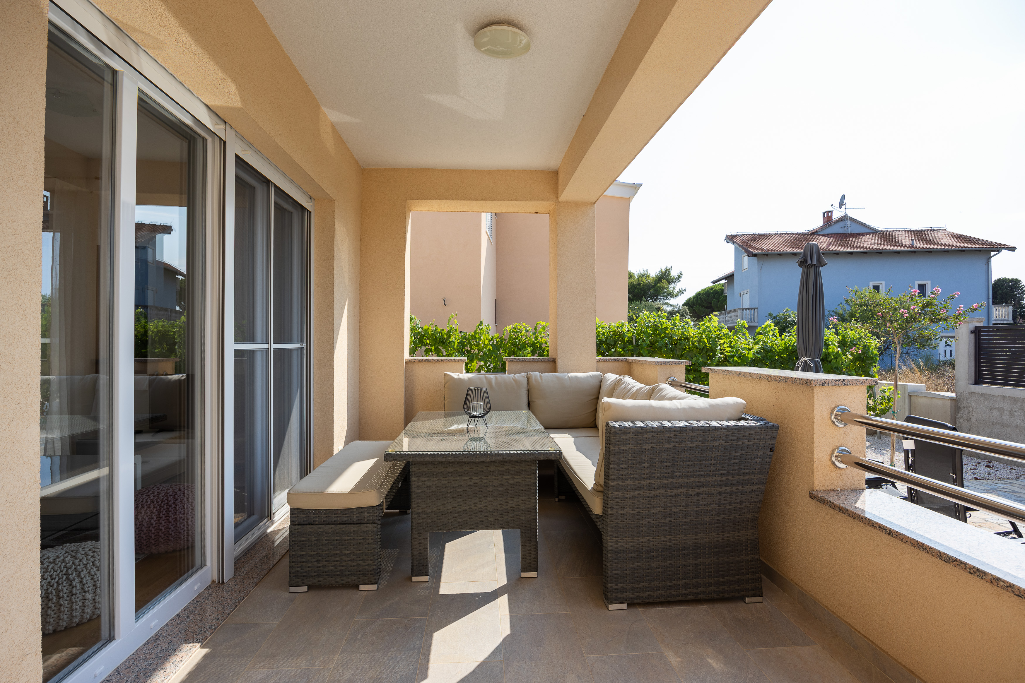 Covered terrace with lounge furniture at Holiday House Šare