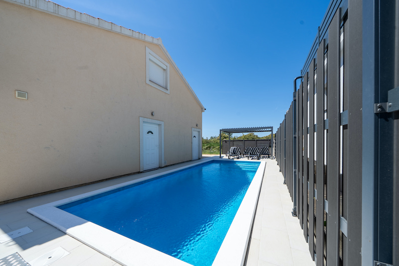 Pool with pergola and sun loungers